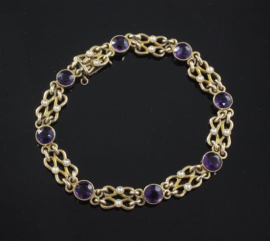 An Edwardian 15ct gold, amethyst and seed pearl bracelet, 17cm.